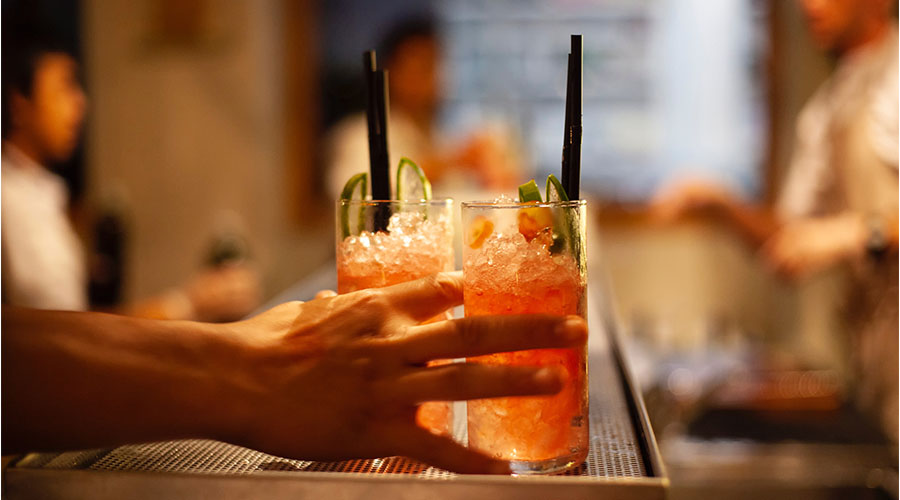 bartender serving two cocktails