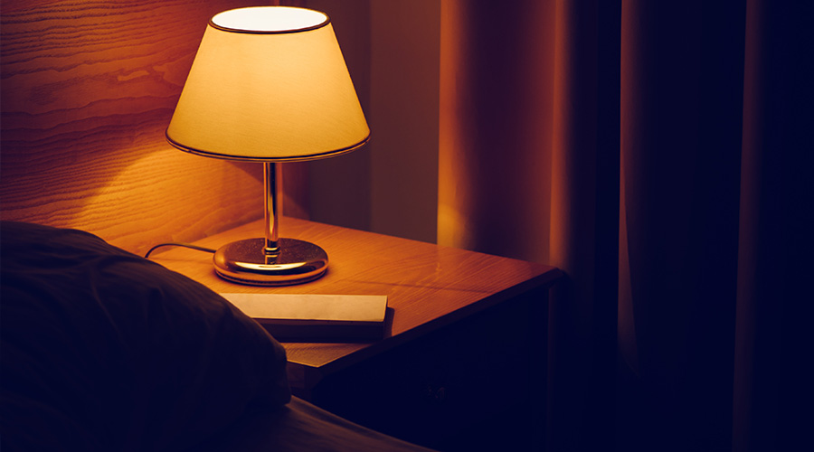 dorm room with ambient bedside table lamp