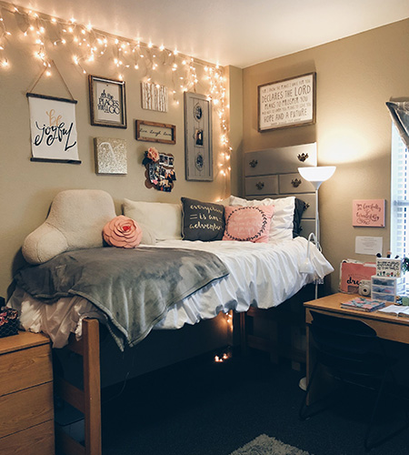 dorm room with fairy lights and space saving furniture