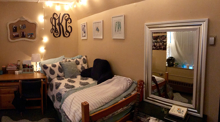 dorm room with mirror and fairy lights
