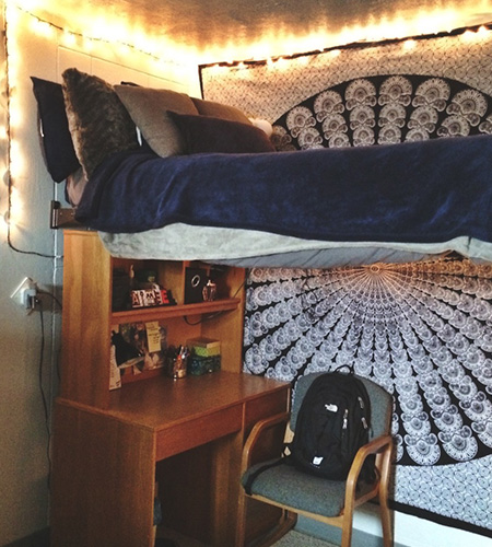 dorm room with tapestry and lights