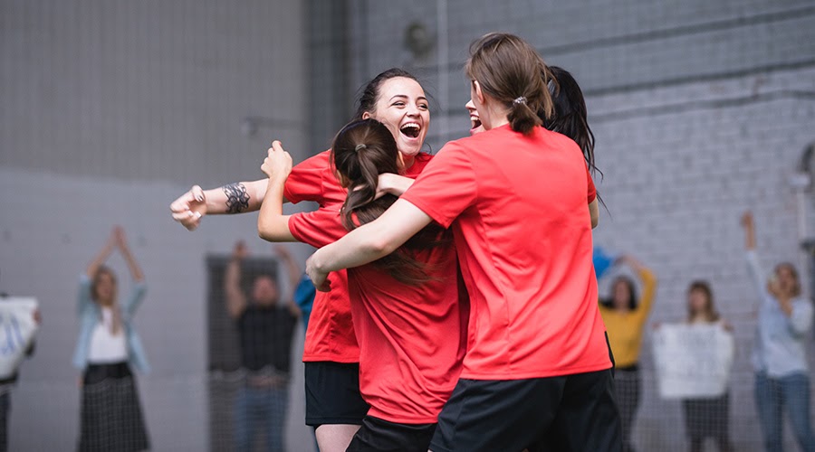 group of students celebrating during a netball match