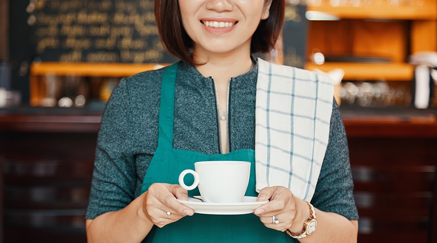 student waitress holding a coffee mug
